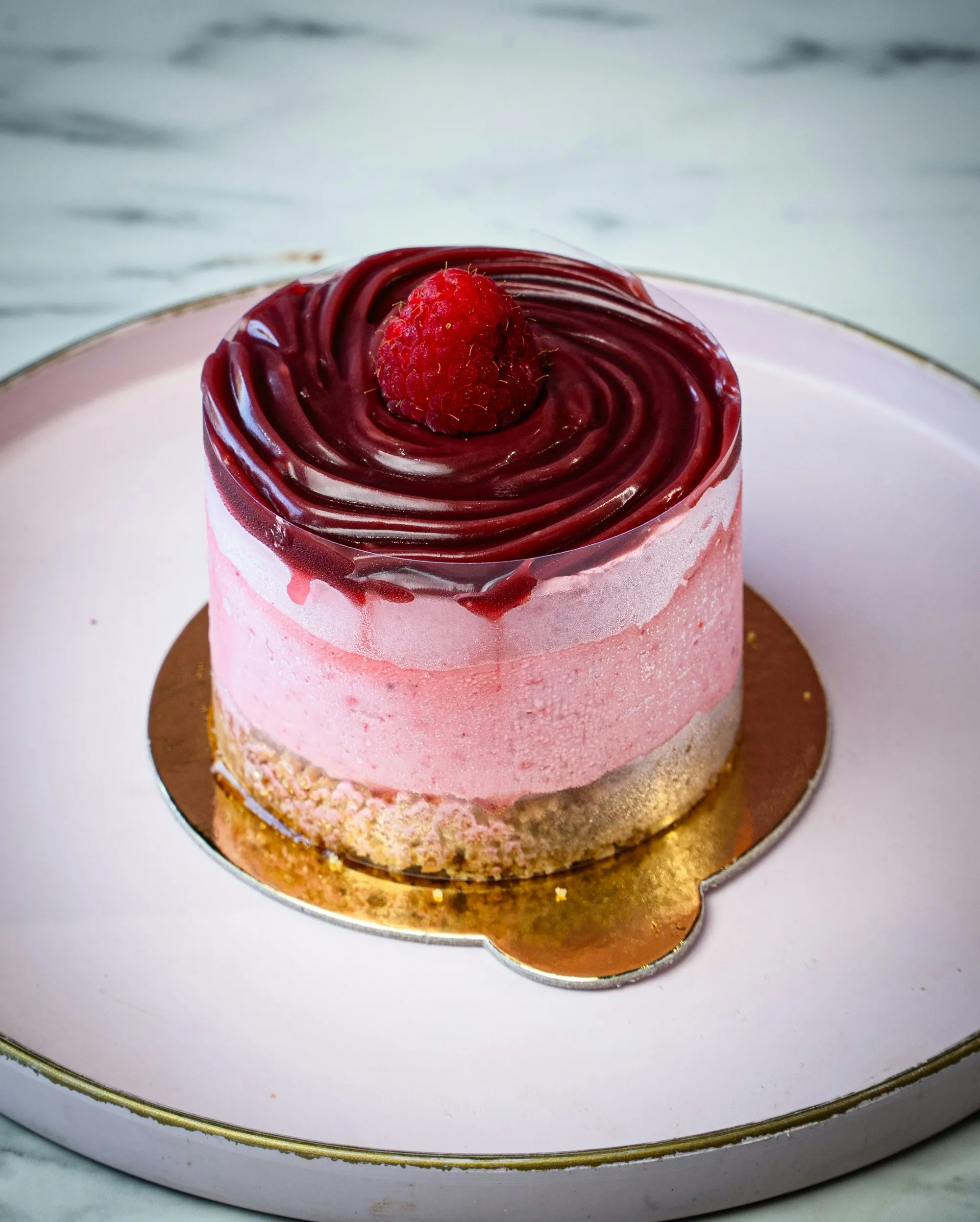 Le Cerisier: a pink cherry mousse cake with a glossy deep red glaze